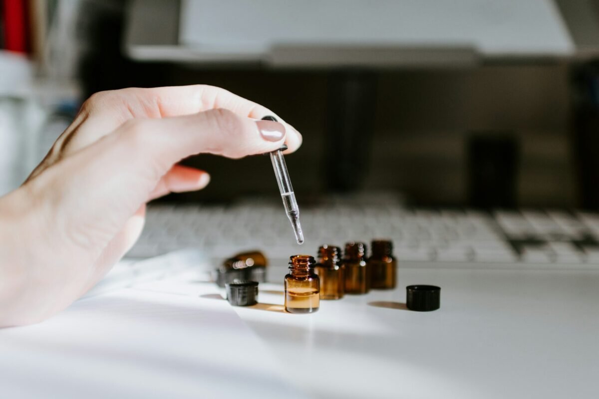 Hand Holding Dropper Bottle