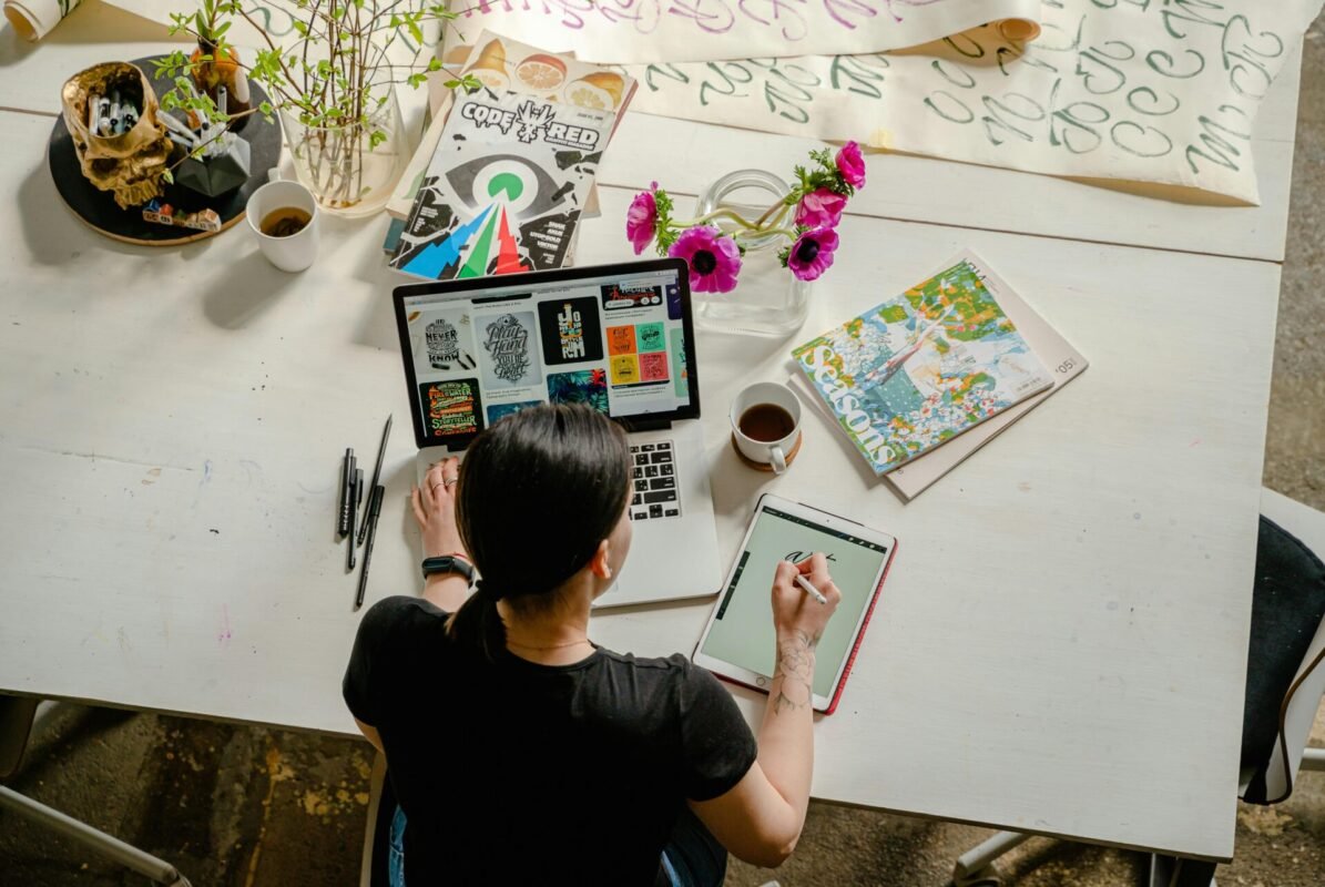 A woman doing hand-drawn logo sketches